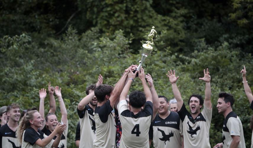 soccer team holds up trophy