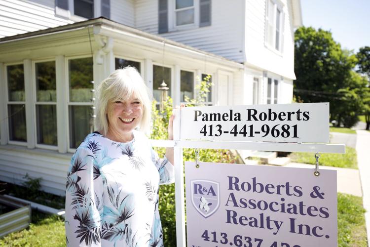 real estate agent posing with sign