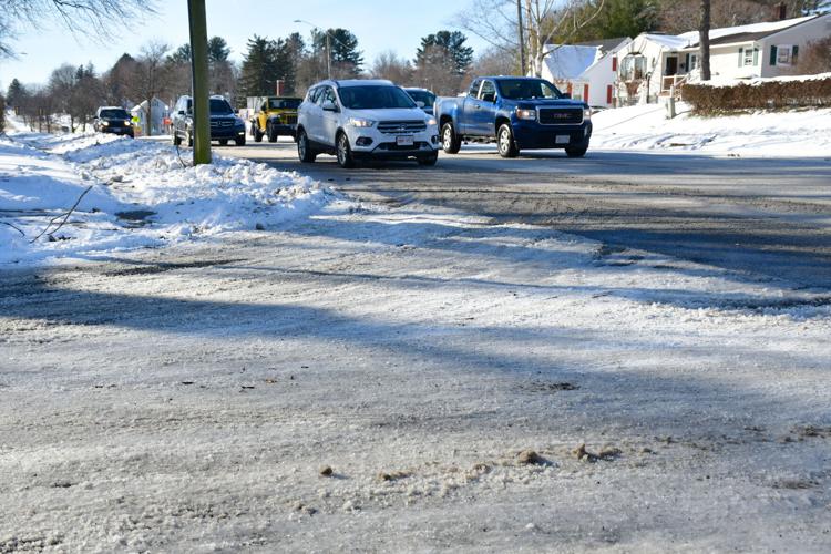 Motorists navigate icy, snowy roads