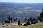 People looks at the view of Adams from the summit