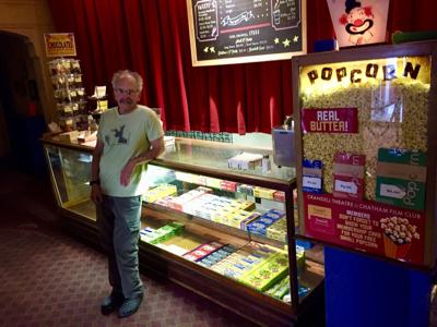 Man leaning on theater candy counter