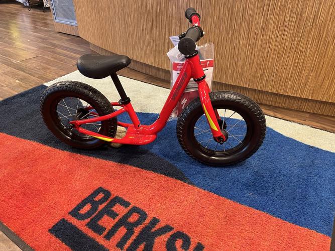 A red child's balance bike