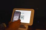 Giblert Clerget scanning a point-of-sale kiosk to pay with bitcoin