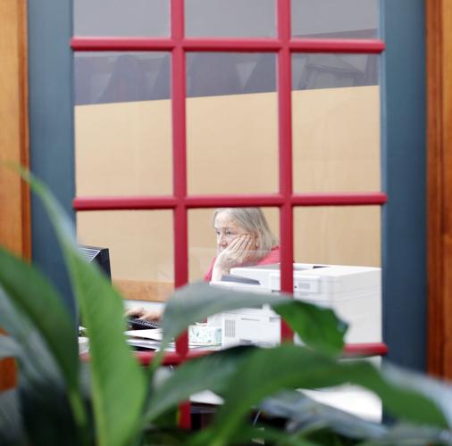 gail molari working at desk through window