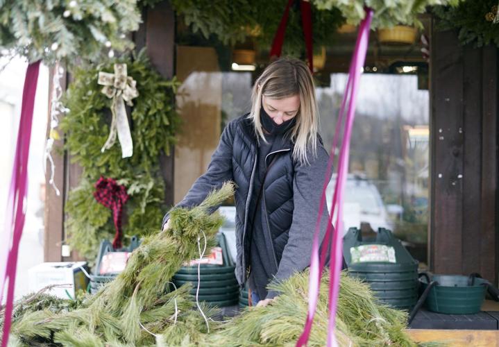 Woman looks at wreaths