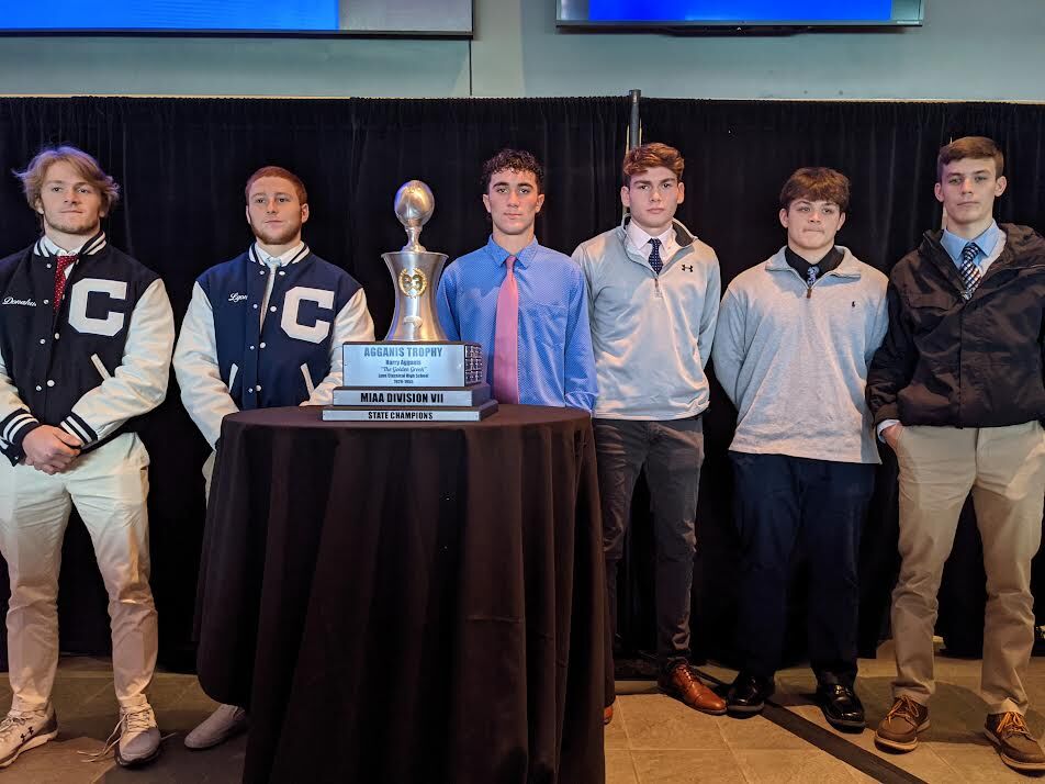 Wahconah and Cohasset football captains with the D-VII trophy