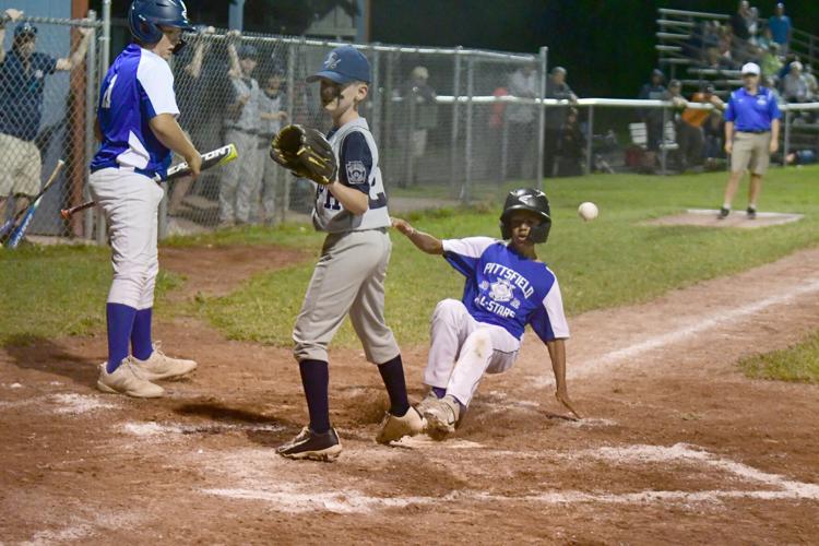 A runner slides into home plate