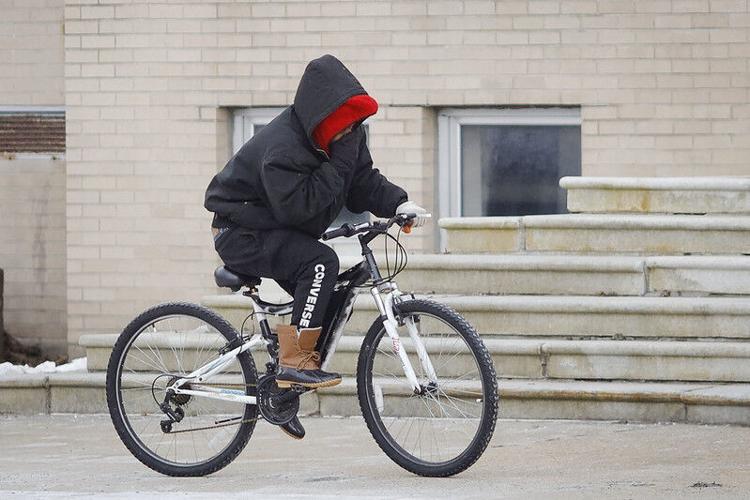 person on bike bundled from cold