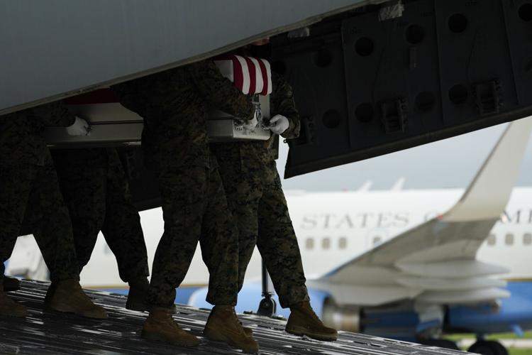 A team moves the remains following an attack at Kabul airport