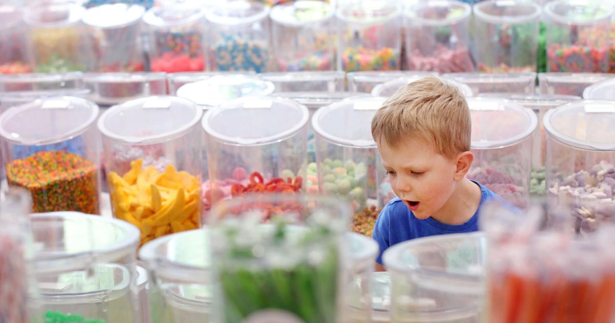 boy gasping in awe in candy store