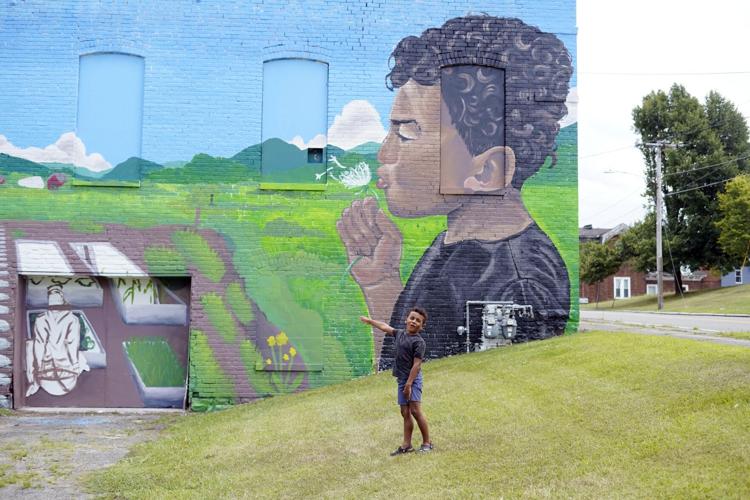 Boy visits mural