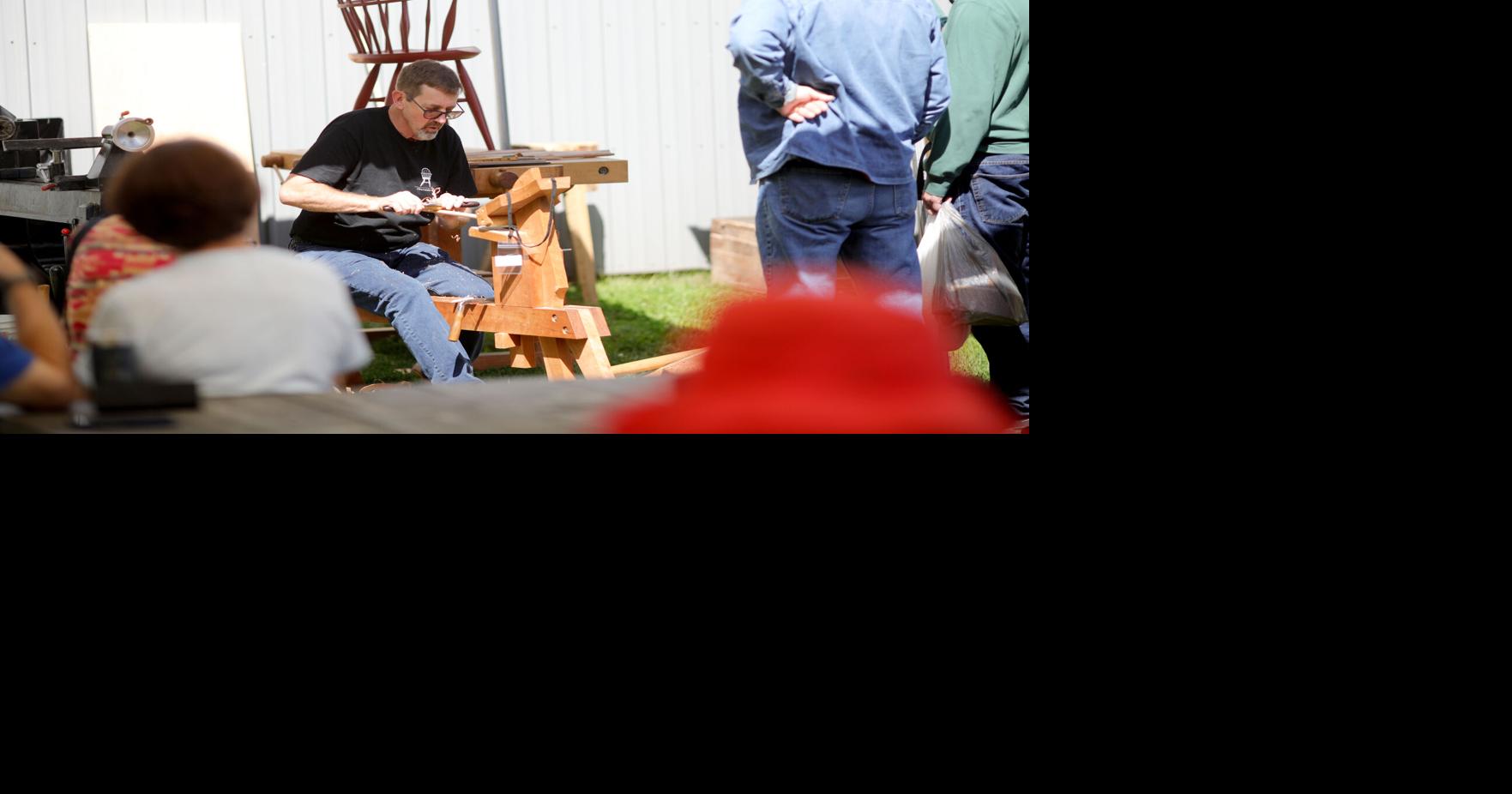 people watching demonstration of wood carving