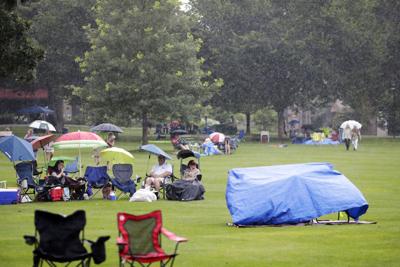 people sit in lawn chairs during rain storm (copy)