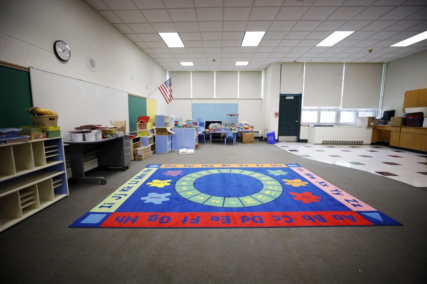 empty pre-k classroom with colorful rug