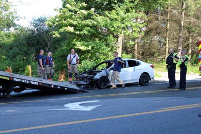 Remains of car being towed away from fire on South Street