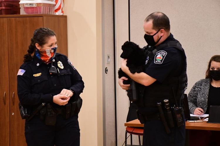 Chief Strout and Officer Miller introduce the puppy to the selectboard