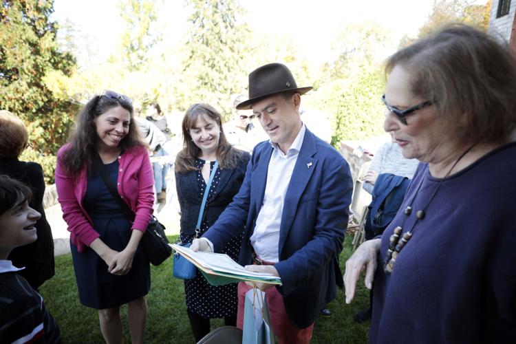 man in hat shows documents to friends