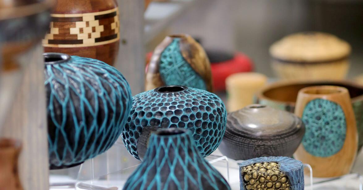 table filled with colorful carved wood pieces