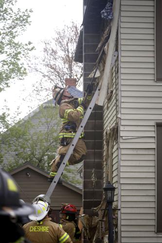 firefighter climbs ladder at home