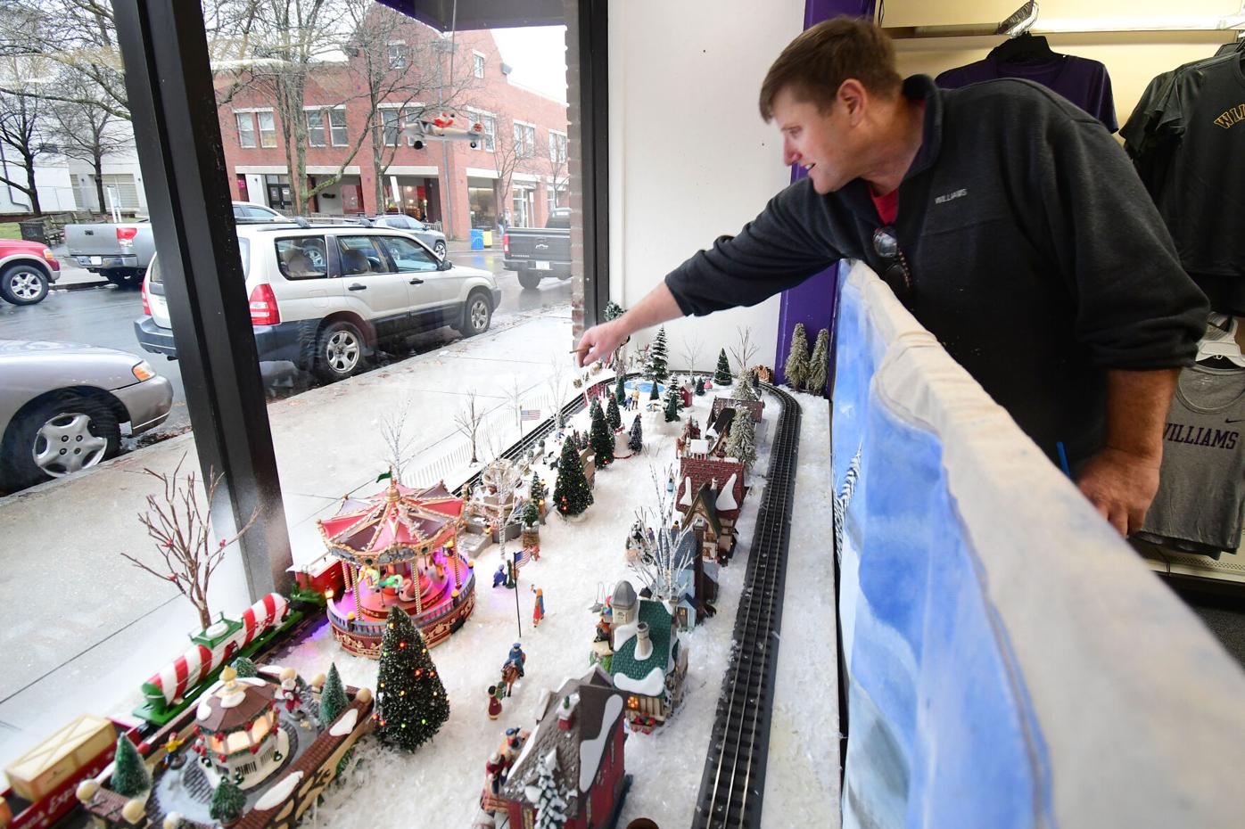 Goff works on the window display of his store
