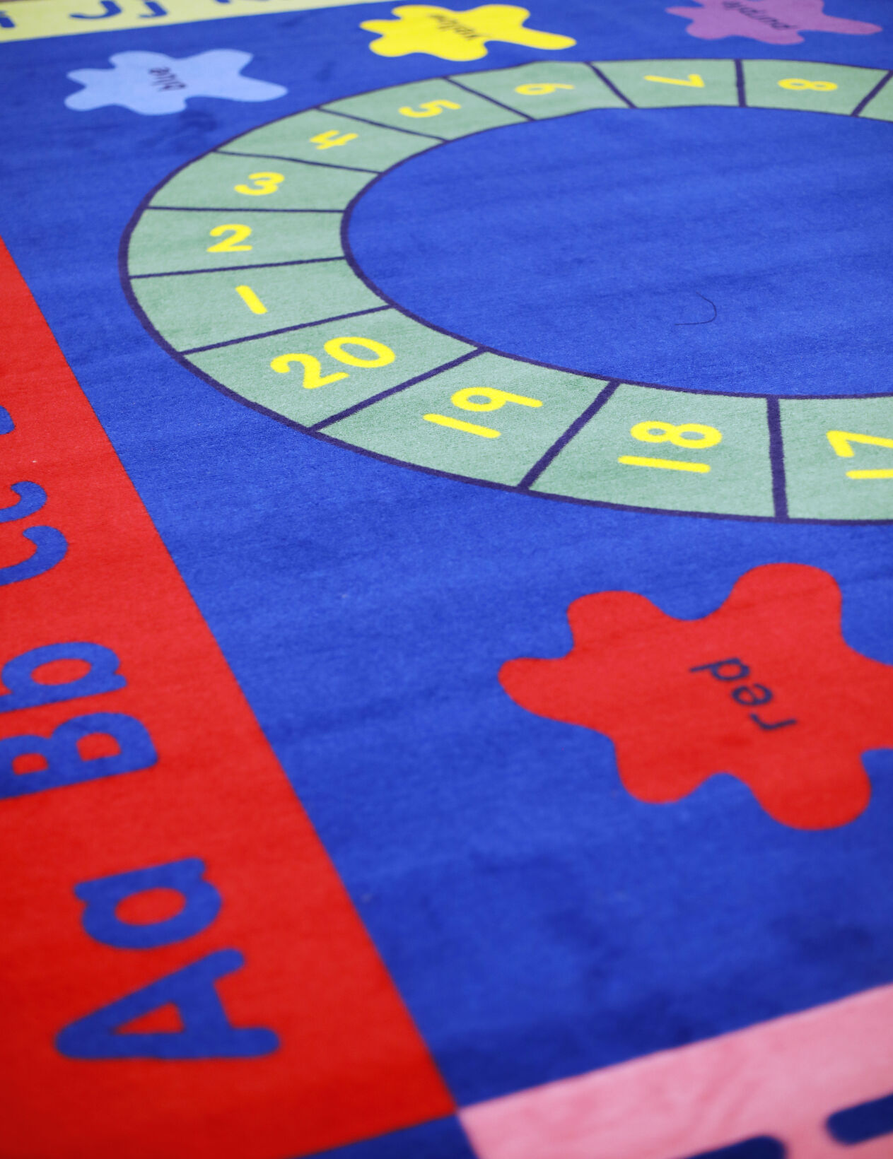 colorful classroom rug with alphabet and numbers on it