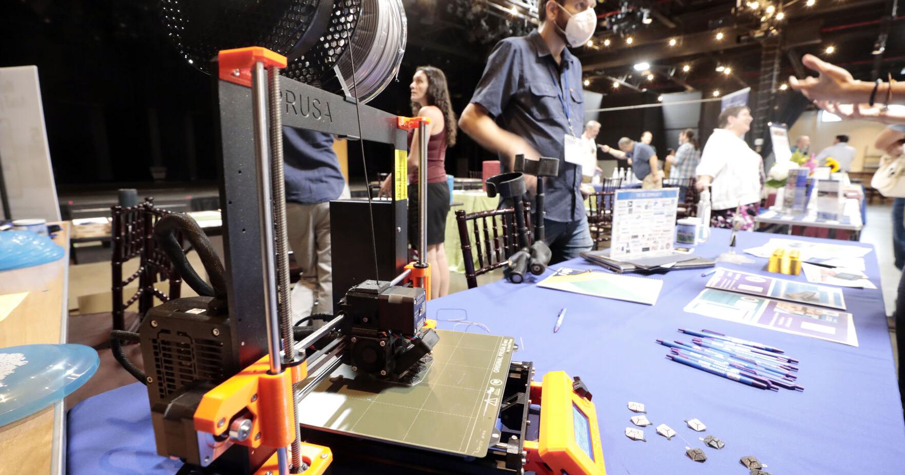 3d printer running on table at expo