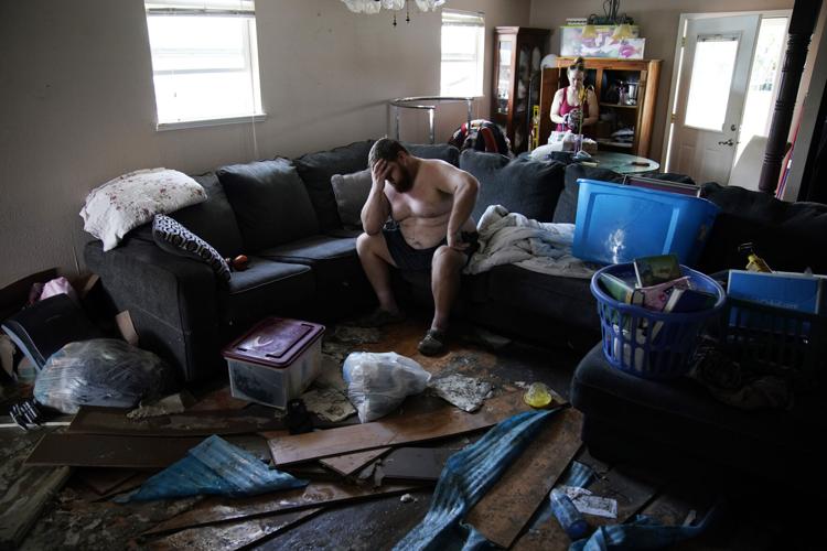 A man feels overwhelmed following the aftermath of Hurricane Ida