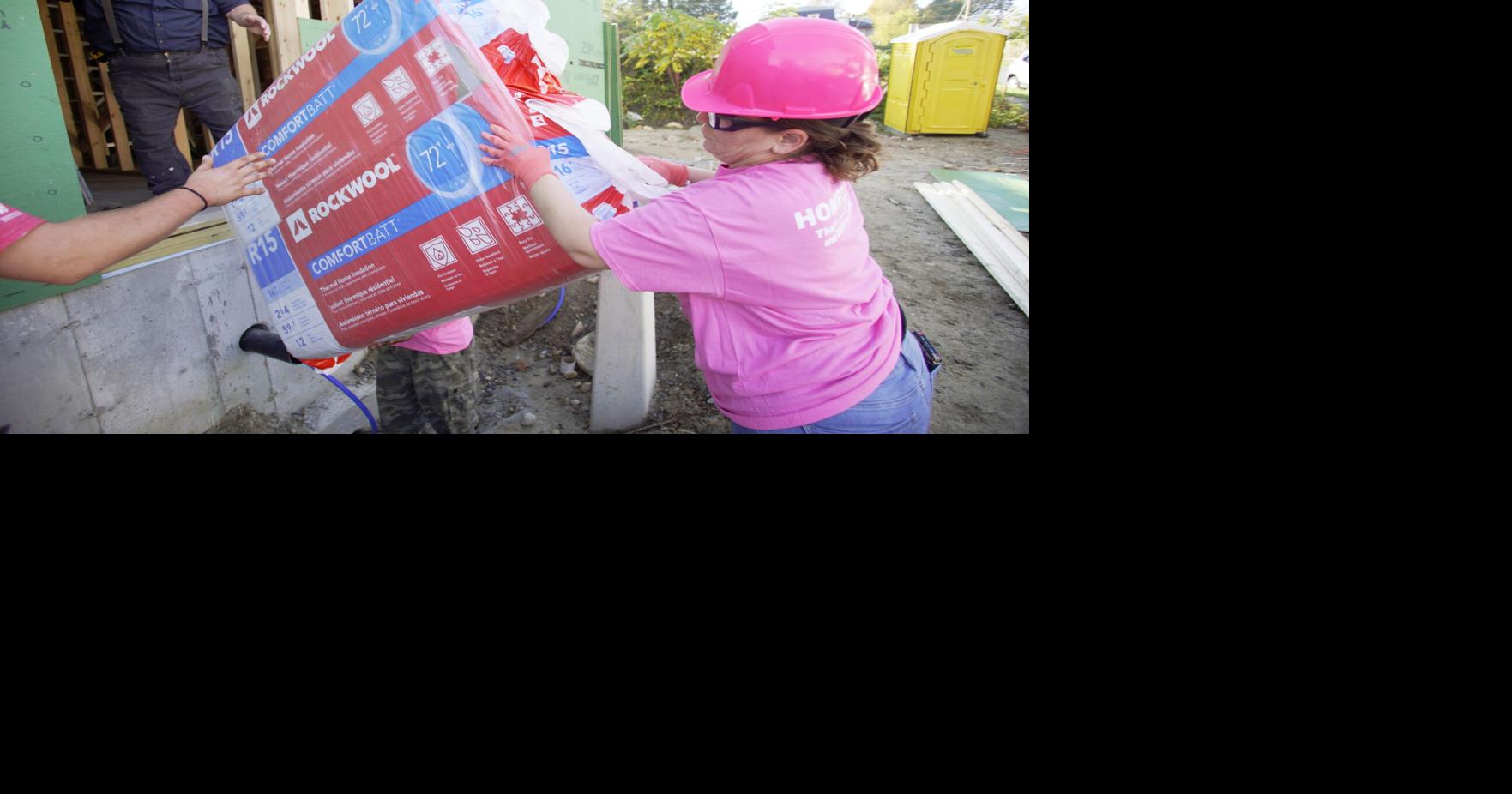 Photos Habitat for Humanity housing lottery winners work on a house as