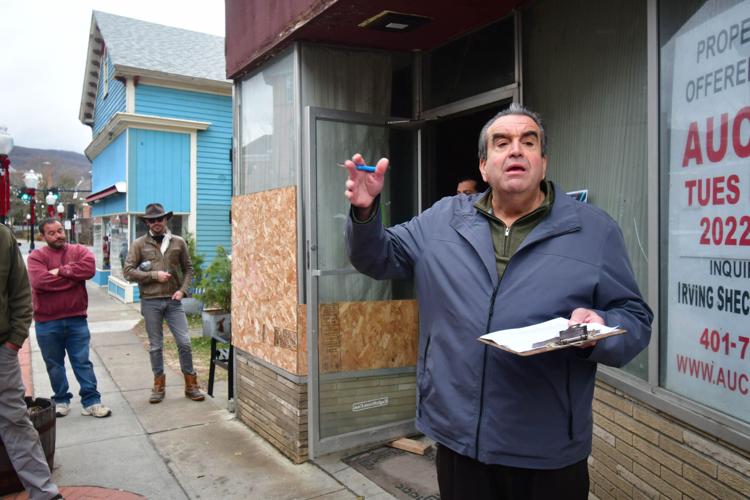A auctioneer leads an building auction