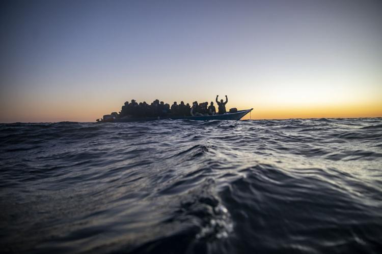 Migrants and refugees aboard a wooden boat