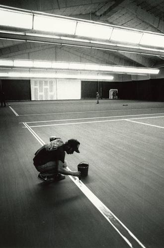 Dana Clark Wilson and Lawrence Corp paint the lines of the indoor tennis court, Sept. 5, 1989