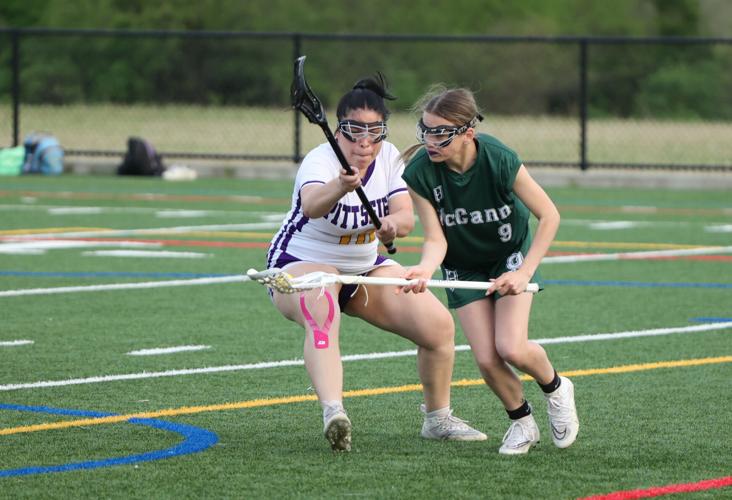 Emma Arnold and Carla Vilnueva play lacrosse