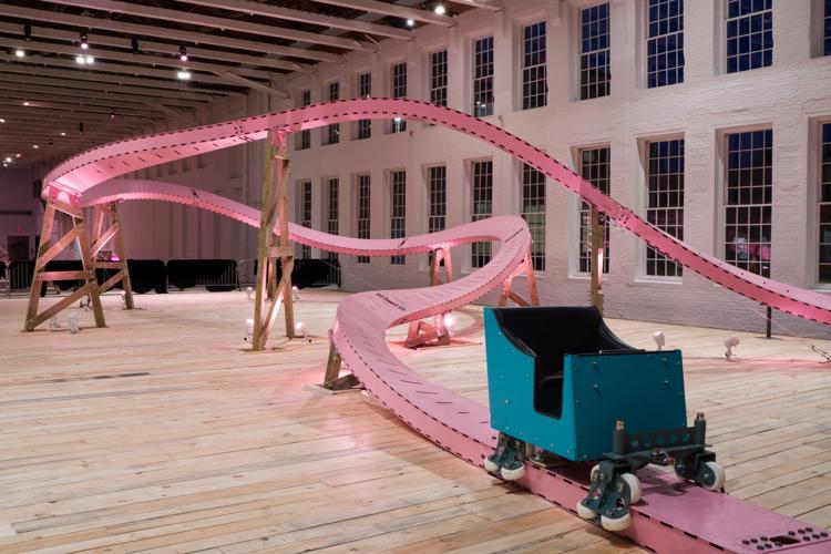 pink roller coaster with a teal cart