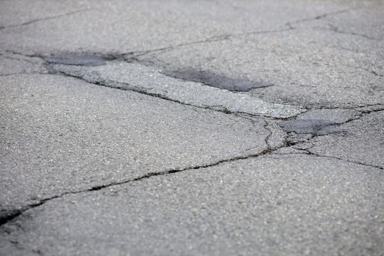 cracked and patched pavement on Dalton Division Road