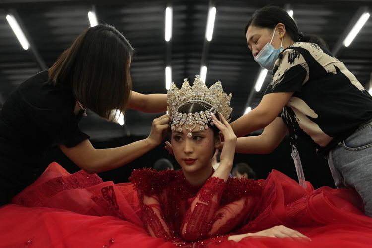A model is assisted during China Fashion Week in Beijing
