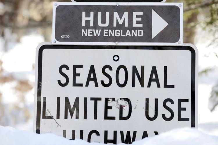 hume new england sign with seasonal limited use sign under it