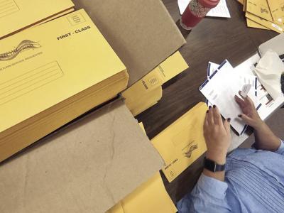 mail-in ballots placed in envelopes