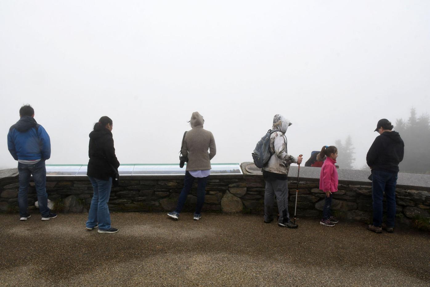 People look out into the fog