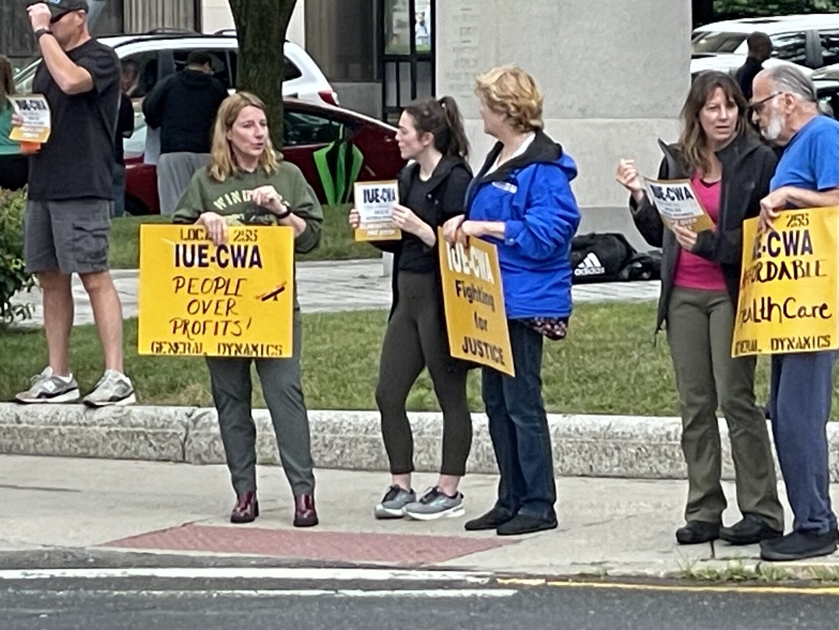 General Dynamics laborers union picket in the rain for company to close its wage gap