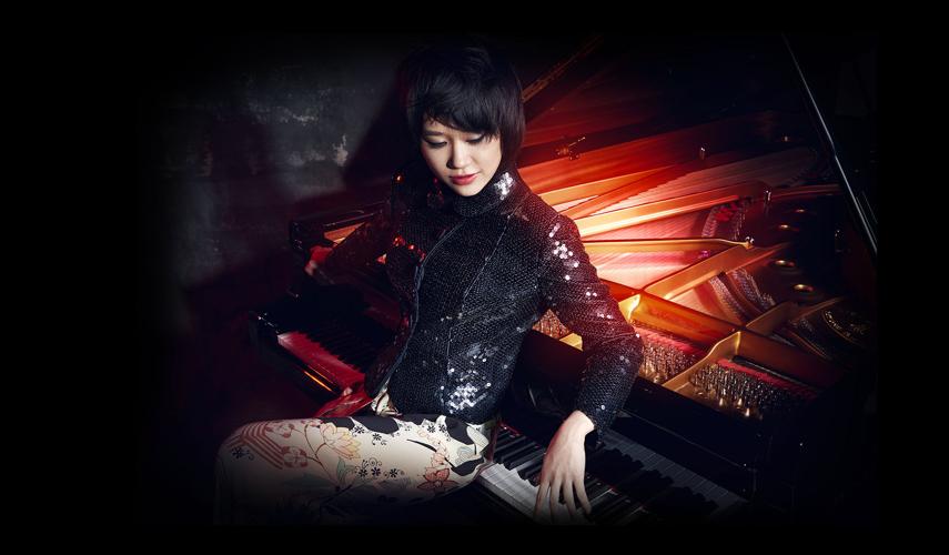 Yuja Wang sitting on piano