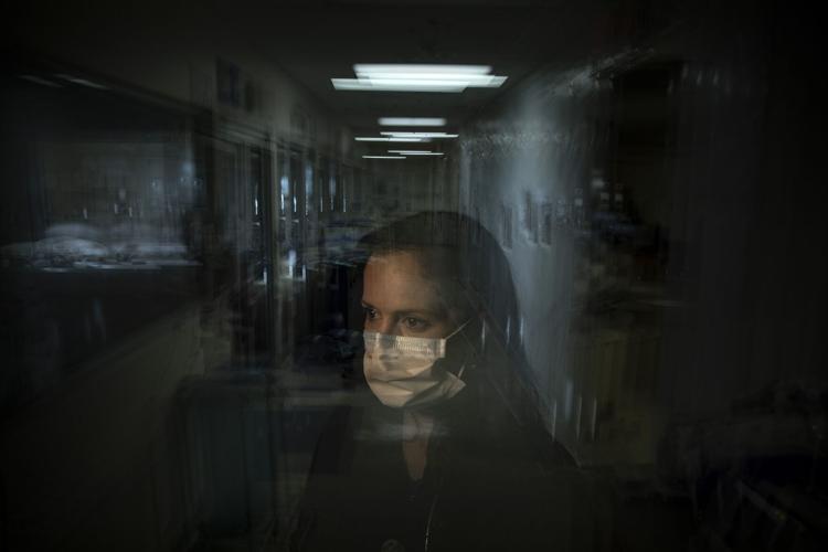 A nurse stands for a photo