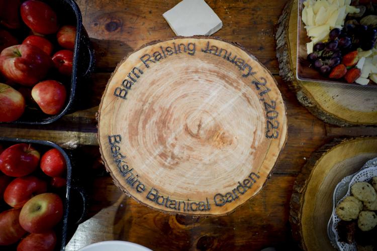 wood block on appetizer table engraved with barn raising date