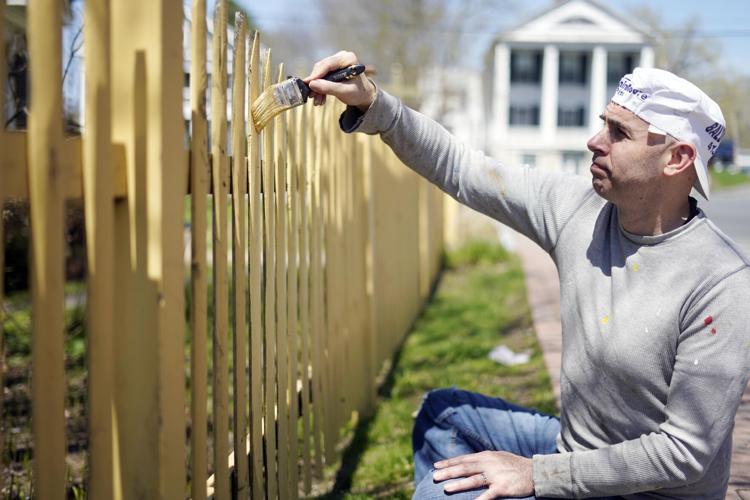 Man painting a fence