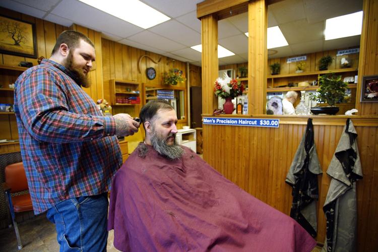 Josh Young has his beard shaved by barber Alec Foisey at Castoldi’s Barber Shop in Pittsfield