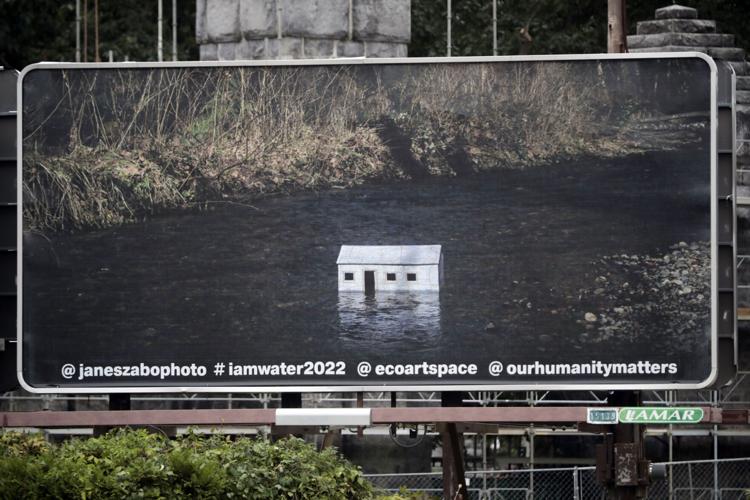 photo of a shack in the middle of flooded river on billboard