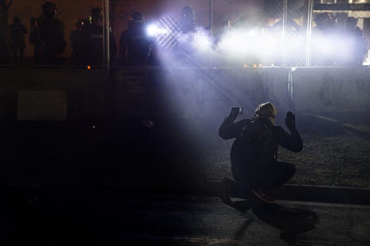 Police shine lights on a demonstrator