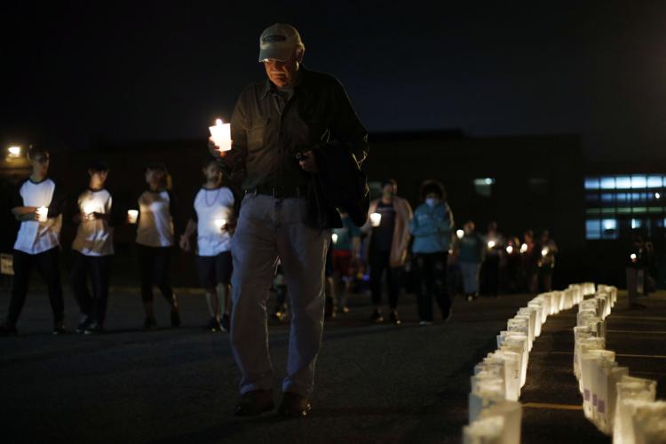 group walks at night with candles at Relay for Life