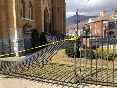 Police tape and broken fence outside church