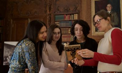 Four women look at a book