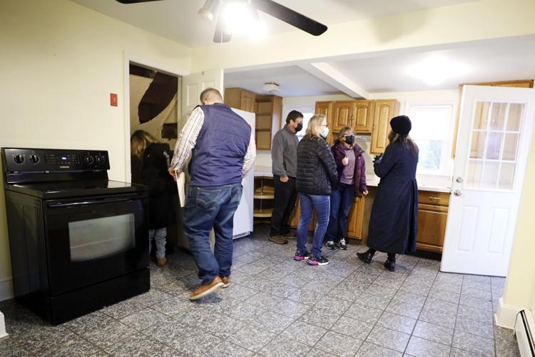 people walking through kitchen of house for sale